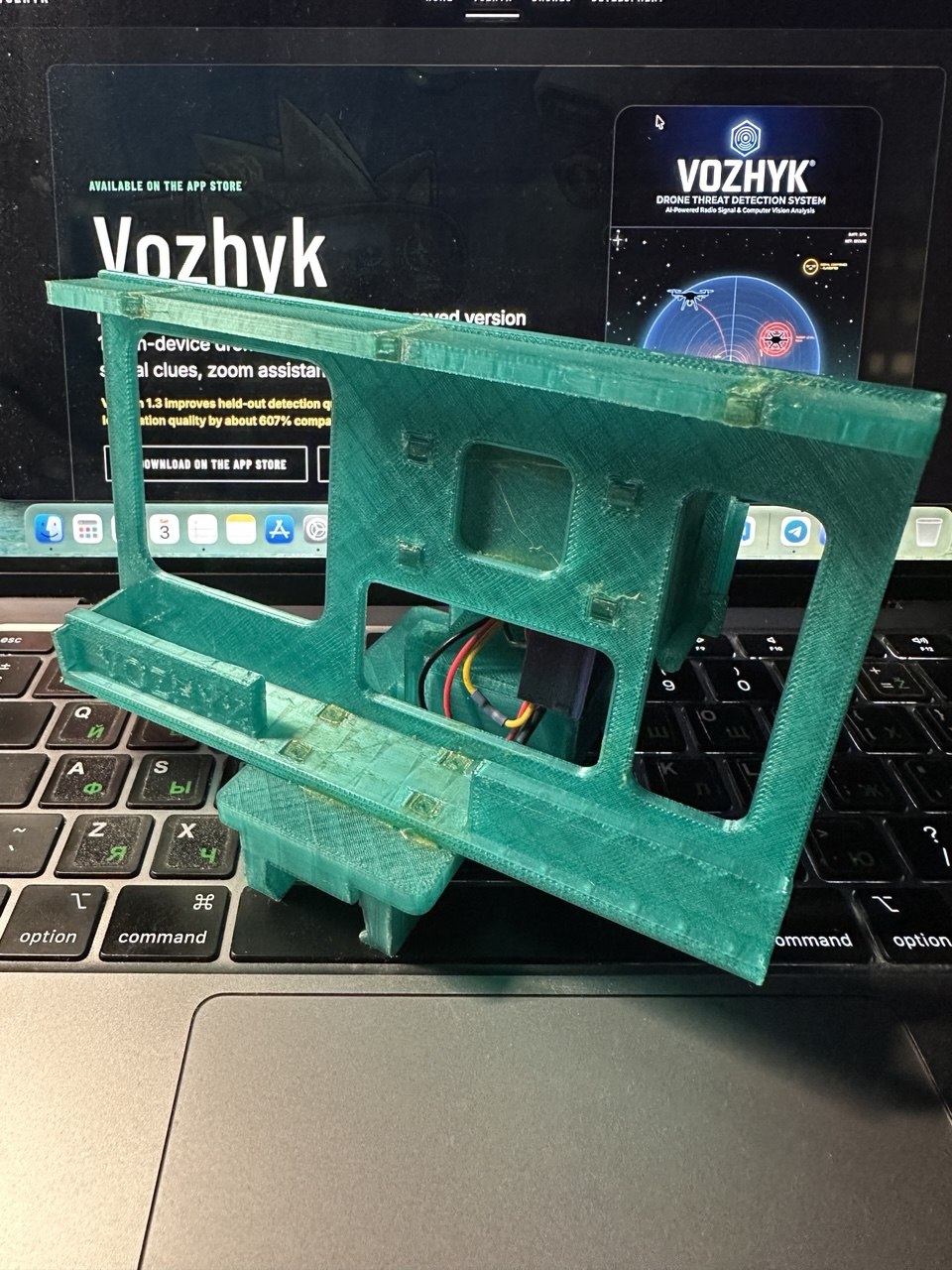 Front view of the green 3D-printed Vozhyk Picatinny attachment prototype